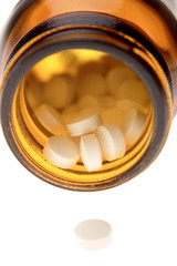Closeup of pills in bottle on white background