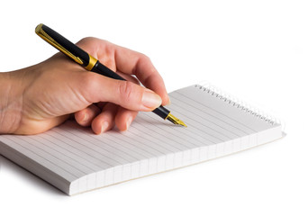 Female hand holding an elegant fountain-pen over reporter's bloc