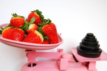 Strawberries on pink weighing scales