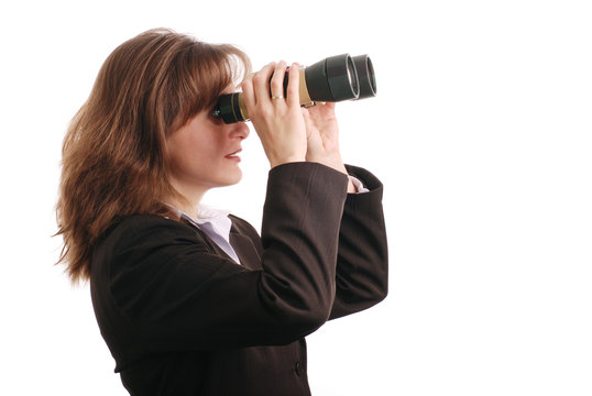 Attractive business woman with binoculars - isolated