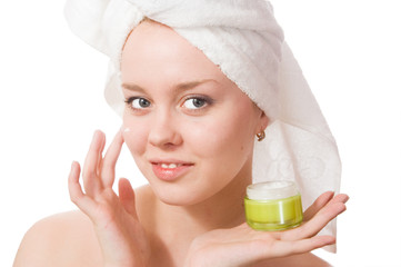 Young girl with towel on her head and cream.