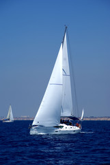 Fototapeta premium Cruising yachts in mediterranean sea on bluesky background