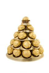 Fototapeta na wymiar pyramid of chocolate sweet isolated on white