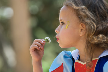 Girl blowing dandelion