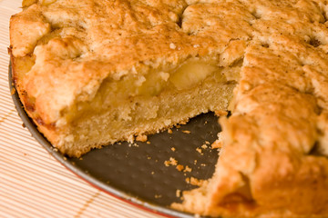 whole apple pie with a piece cut out