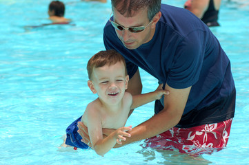 Fototapeta na wymiar Dad Teaching Son to Swim