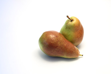 Two ripe red and green pears lying on white background