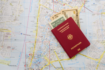 German travel pass with dollar notes over the map of New York