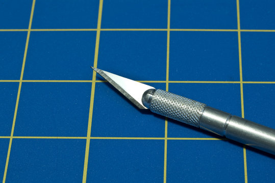 Stainless steel razor knife on a blue cutting knife