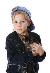 Young boy cuddling pet cat