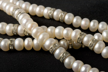 Pearl necklace on black background