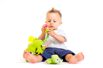 Fototapeta premium Baby plays with toys