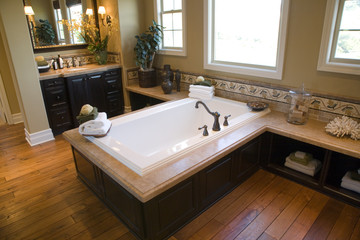 Designer bathroom with a modern tub and hardwood floor.
