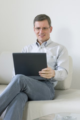 Man on couch with laptop computer