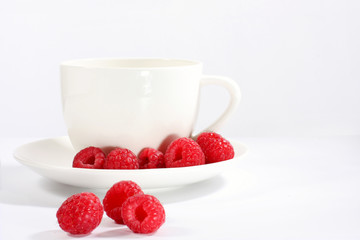 Cup of tea with raspberry
