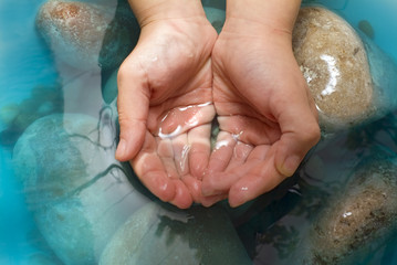 hands stones water
