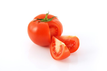 cut tomato with two slices isolated on white