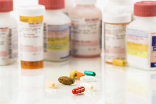 Close up of assorted pills and prescriptions