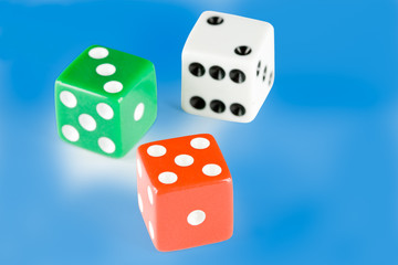 Three dice pieces on blue background