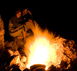 People near campfire in forest