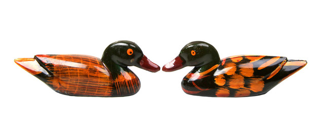 isolated two wooden ducks face to face