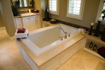 Designer bathroom with a modern tub and tile floor.