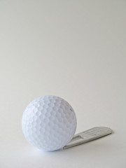 Golf ball and repair tool
