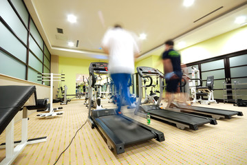 Man running on treadmill in gym
