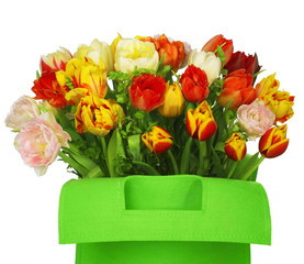 green bag with beautiful tulip bouquet. clouse-up. isolated 