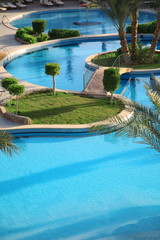 Holiday hotel and open air resort style swimming pool.