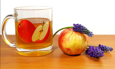 Ripe apples, juice and flowers