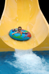boy going down slide at waterpark
