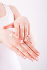woman applying cream on her hands