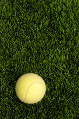 yellow tennis ball on the man-made lawn