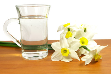 Bouquet of narcissuses and a cup