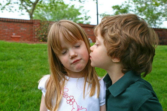 A boy kissing a girl