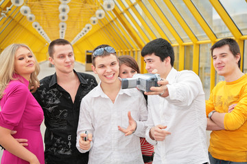 group of young people removes itself to camcorder on footbridge
