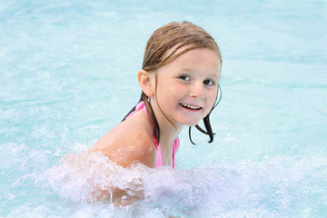 Fototapeta na wymiar Happy girl in a pool