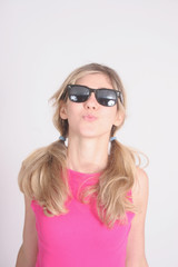 Blond woman in sunglasses puckering to kiss