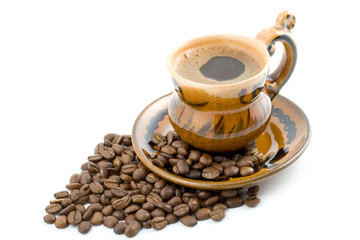 Coffee beans and black coffee in a cup