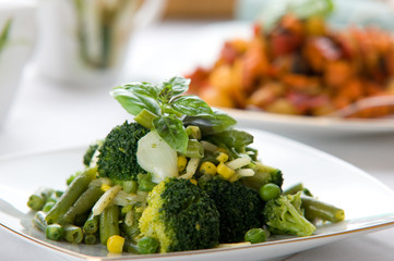 Fresh green vegetable salad with corn and basil