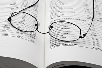 Reading glasses on open business book