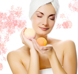 Lovely young woman with aroma bath ball in her hands.