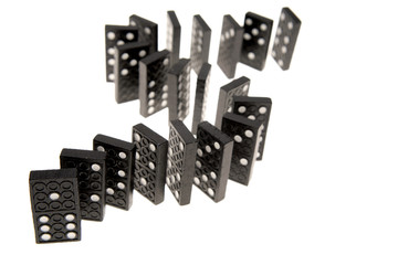 Dominoes standing on white background