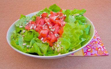 fresh green salad with tomatoes and sunflower seeds