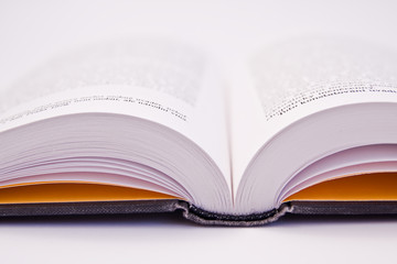 a close-up of open book on white background