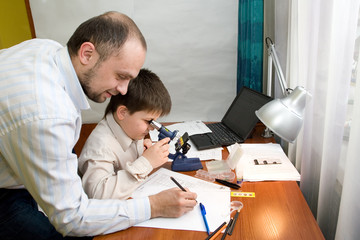 boy with a microscope in a laboratory