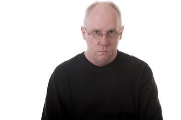 Old Guy in Black Shirt Looking Stern Over Glasses