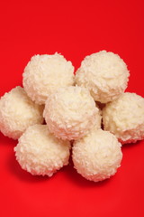 Delicious chocolate balls on red background