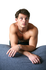 Obraz premium Sexy Muscular Man Leaning on the Sofa